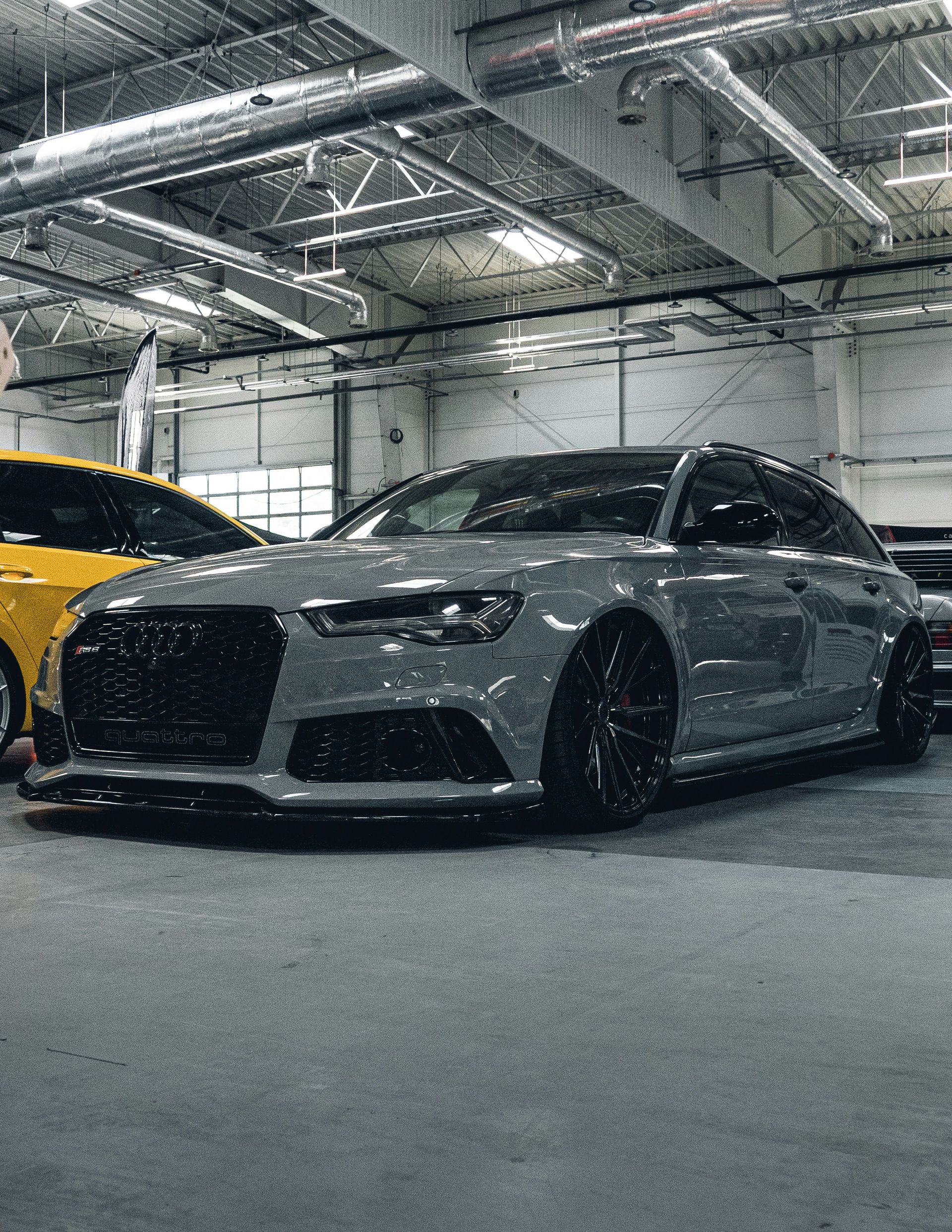 A couple of cars parked inside of a garage