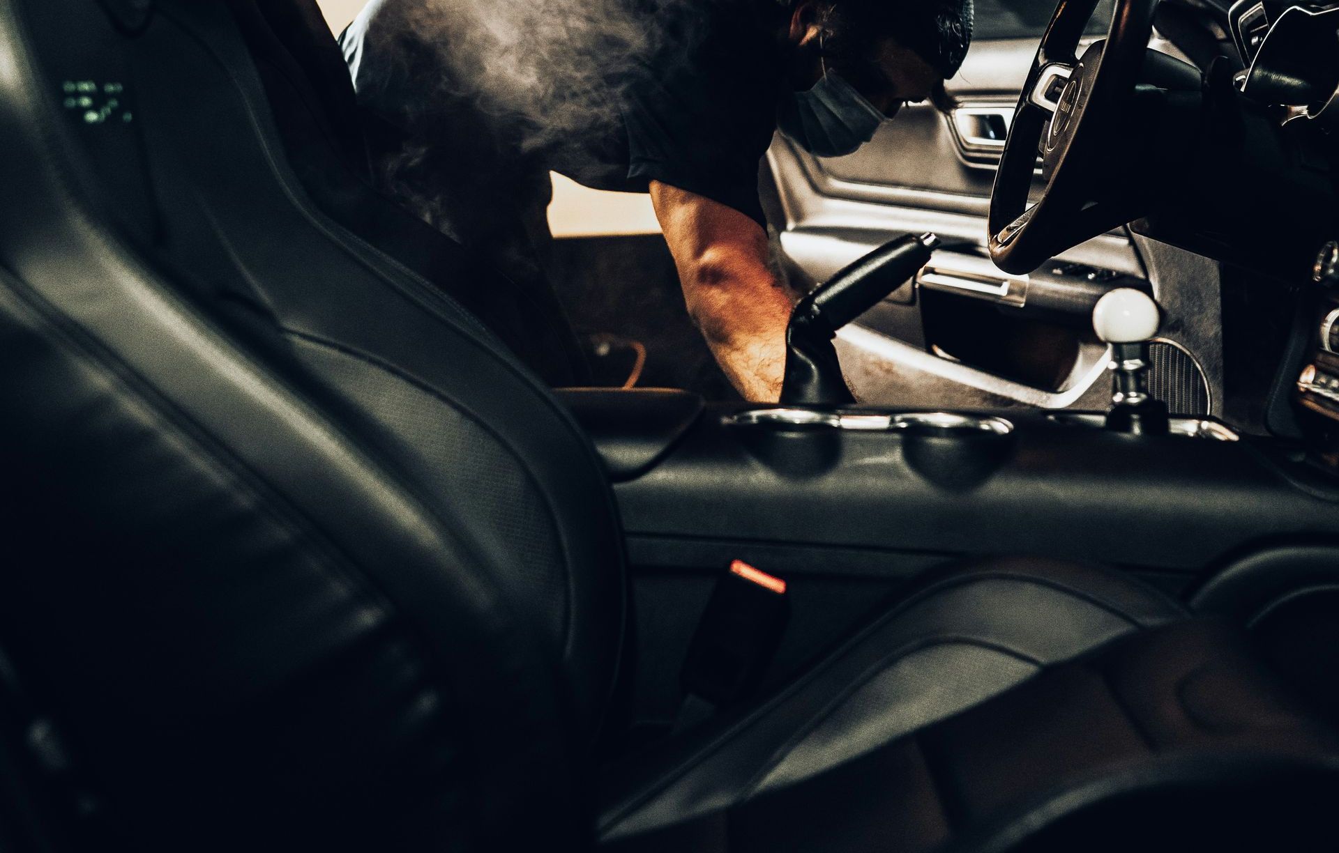 man in black t-shirt driving car